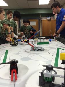 Weapons of Math Instruction discuss their robot with the judges.